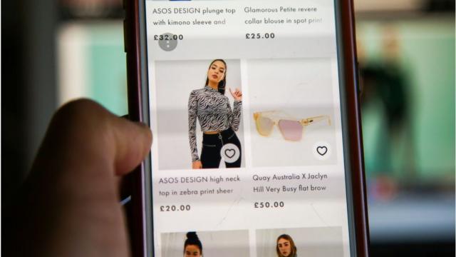 A woman scrolling on the Asos website on mobile