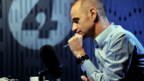 Davies on the radio with a mic