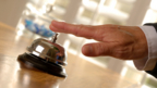 Person's hand ringing reception style bell.  From iStock.