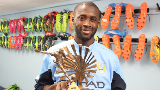 Yaya Toure holding the 2013 BBC African Footballer of the Year Award