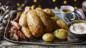 Roast chicken with sausage and bacon rolls, bread sauce and gravy-roasted potatoes