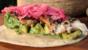Crisp sea bass tortillas with pink pickled onion