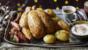Roast chicken with sausage and bacon rolls, bread sauce and gravy-roasted potatoes
