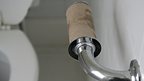 A universal symbol of a blokey house - no loo roll!