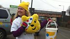 Louise from BBC Children in Need shakes a bucket