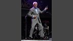 Roy is brilliant at the air guitar during his rendition of 'Sweet Caroline'.
