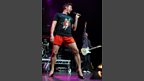 John managed to not fall over once despite the precarious footwear as he performed 'I Kissed a Girl'.