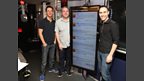 Dave, Chris and Aled model the enormous screen in the studio where your messages of support are displayed.