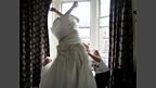 Host Andrina alters wedding dresses. So naturally Greg had to try one on!