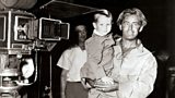 Photo of Alan Ladd with his son David on the film set of Shane.