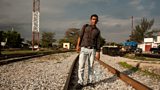 A migrant taking the rail route north through Mexico