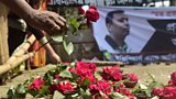 A social activist lays a rose at a memorial to murdered blogger Avijit Roy