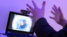 A man controlling a computer through gestures