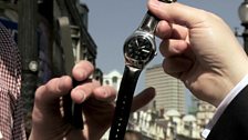 A man holding a watch