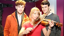 Image for Thursday: Clean Bandit teach Sara the violin