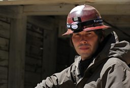 Prof Brian Cox entering one of California's last remaining gold mines