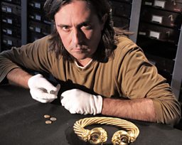 Neil examines gold jewellery and early coins