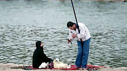 A man and a woman fishing on the Wadi Hanifah