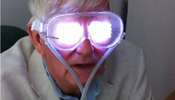 Geoff Watts in Dominic Ffytche’s lab, wearing a device that stimulates hallucinations