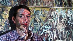 Alastair Sooke in front of a projected image of Coppo di Marcovaldo’s 'Last Judgement'.