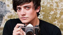 Aneurin Barnard holding a Pentax camera