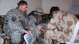 Former US Army captain Blake Hall (far left), in Iraq with his interpreter "Roy" (right)