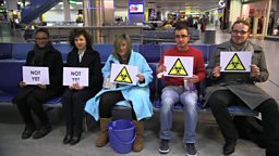 Five people on a bench looking ill