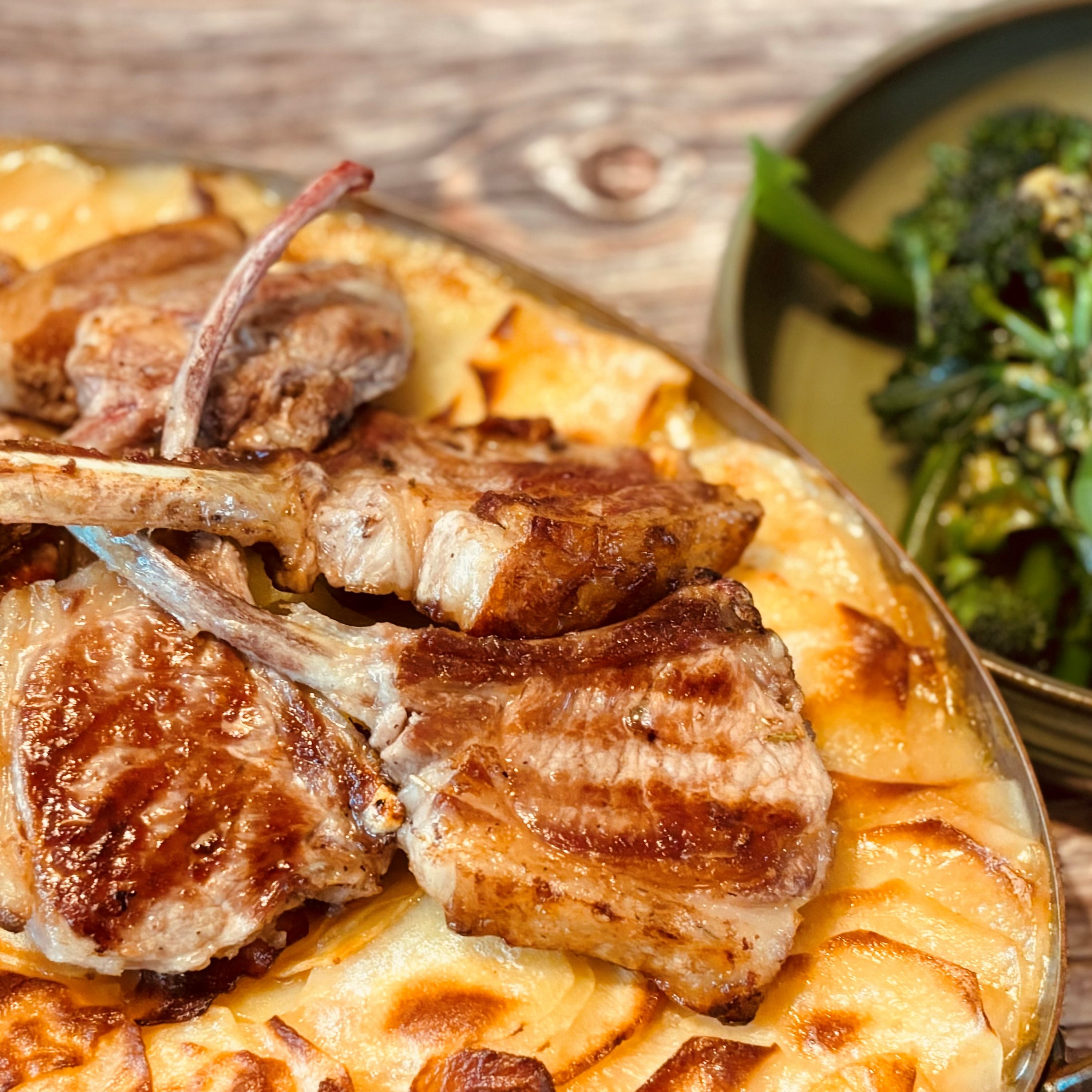 Grilled lamb chops with hotpot potatoes, purple sprouting broccoli with anchovy dressing