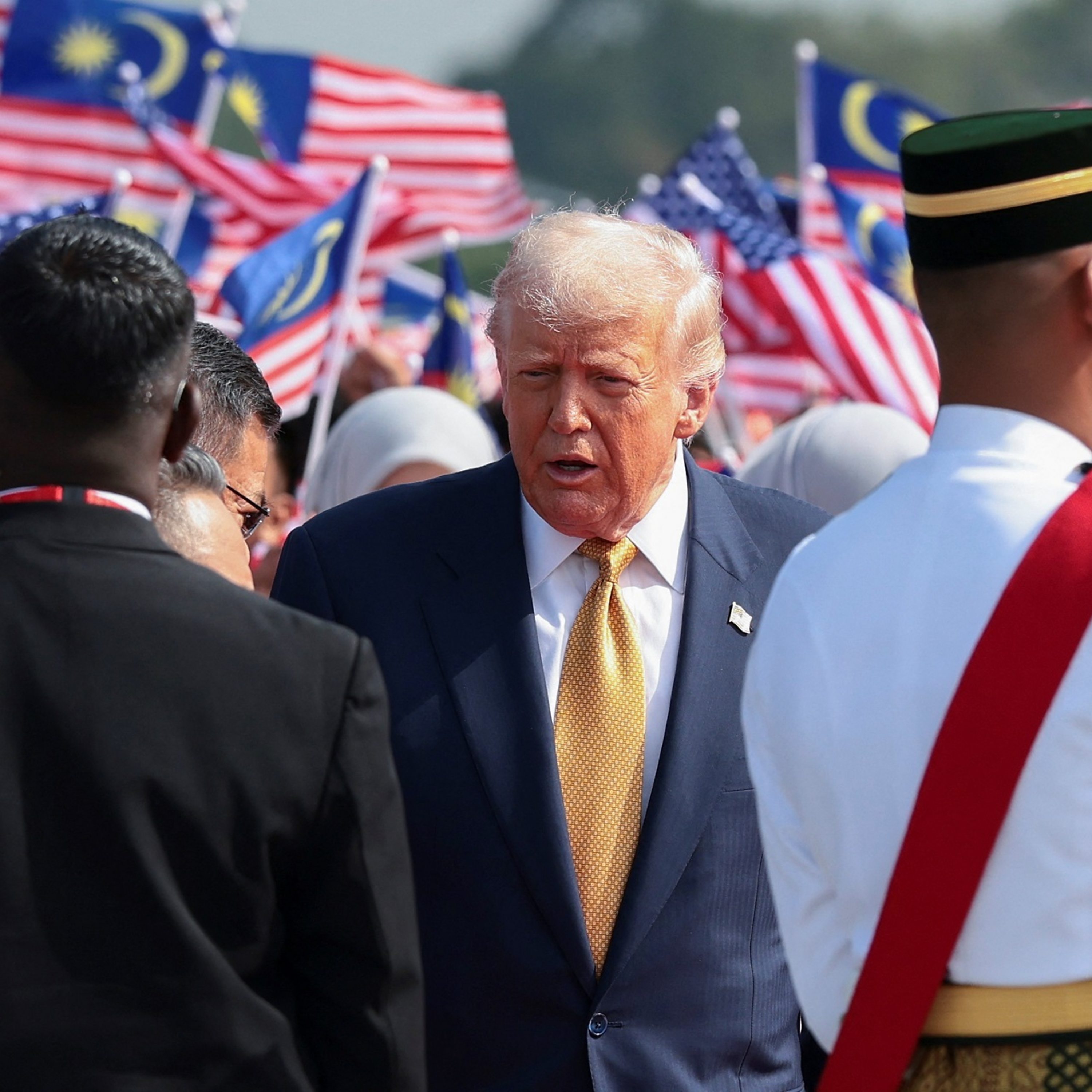 Handshakes and trade deals as Trump tours Asia