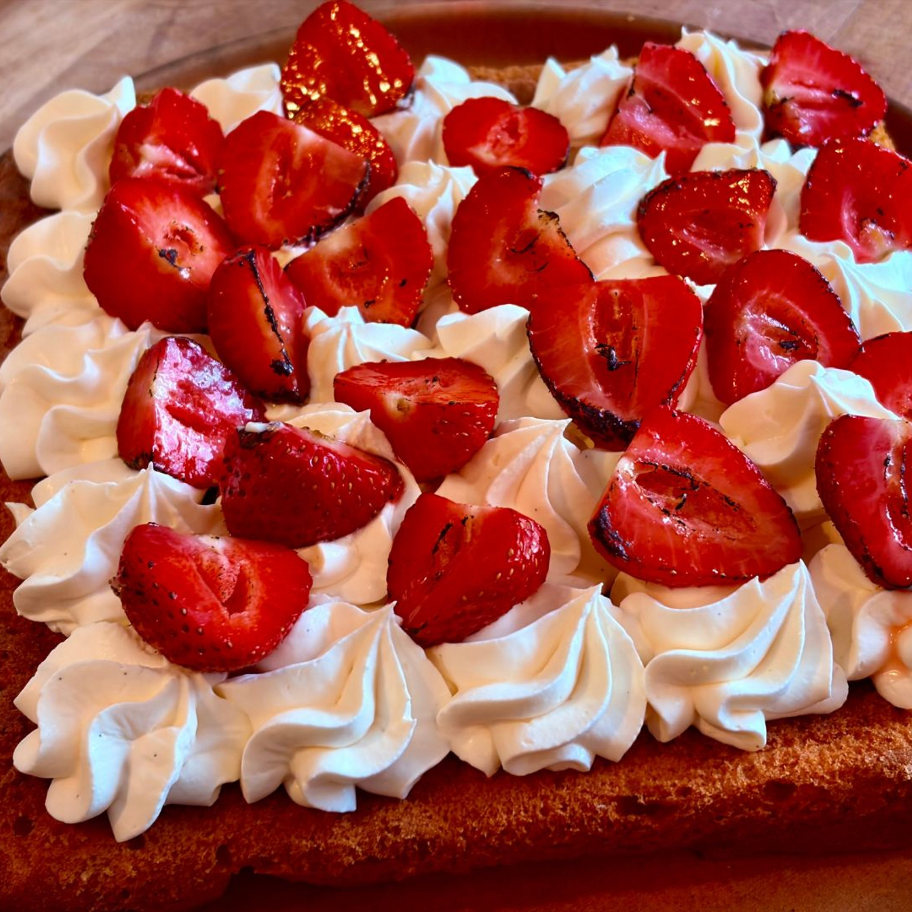 Peanut Butter Slice With Vanilla Cream And Flamed Strawberries