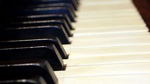 Image for 'The piano is resting on his back...'