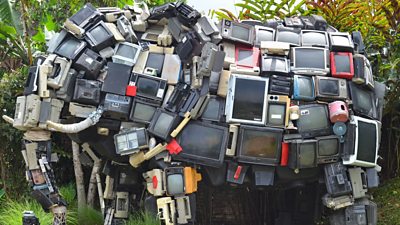 A collection of old audio/video equipment shaped into the sculpture of an elephant.