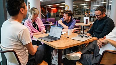 Group of Ģ������Ƶ colleagues collaborating around a table with laptops