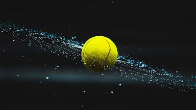 Tennis ball flying through the air with water droplets spraying off it in a circular pattern around the ball.