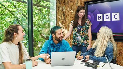 Four Ģ������Ƶ colleagues sitting together in a meeting room