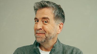 A head and shoulders shot of Mark Chapman, smiling with his head to the side