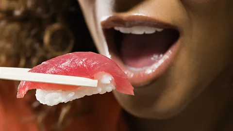 Woman eating sushi