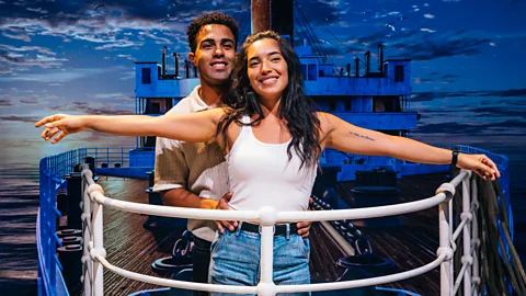 A couple recreate the famous arms-wise pose from the Titanic film (Credit: FKP Scorpio Entertainment)