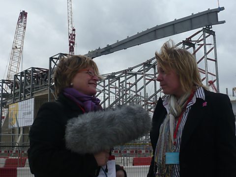 Sheila Dillon and Ros Seal in front of The 2012 Aquatic Centre designed by Zaha Hadid
