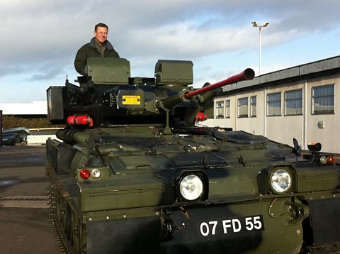 Presenter Francis Tusa in a Scimitar armoured vehicle.