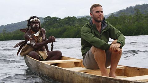 Gary Barlow being rowed by tribesmen in the Solomon Islands