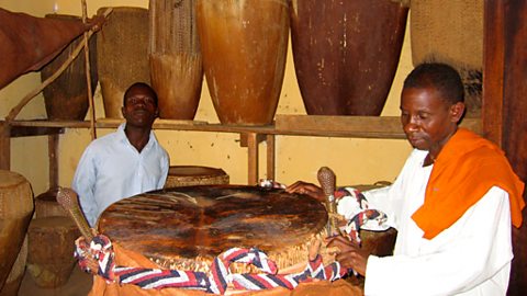 The keeper of the Royal Drums with the Royal Drum, Kampala