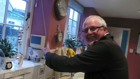 Richard in his kitchen with the Cooker Minder developed by BIME