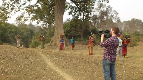 Filming women collecting wood