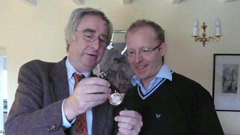 Peter Day and Roger Smith examining one of his wristwatches