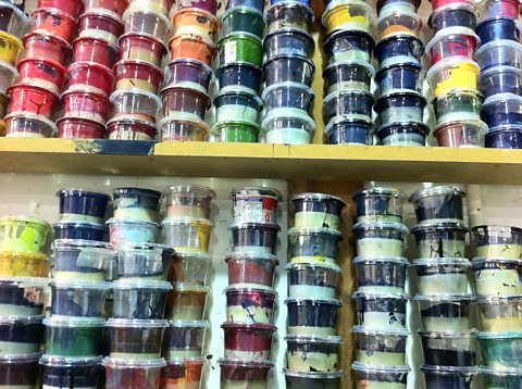 Pots of lithographic ink stacked against the wall of the Curwen Studios