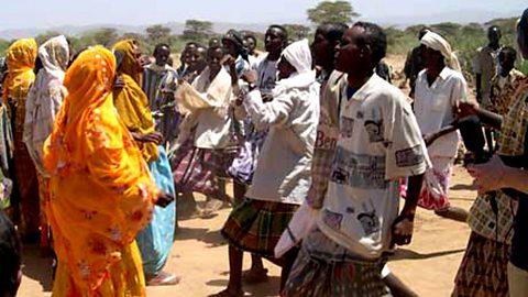 The men and women perform a traditional dance