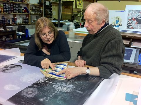 Susan Aldworth and Stanley Jones inspecting the lithographic print they are working on together