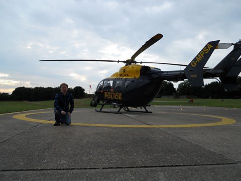Paul Farley next to "India 99" at the Metropolitan Police Air Support Unit in Epping Forest