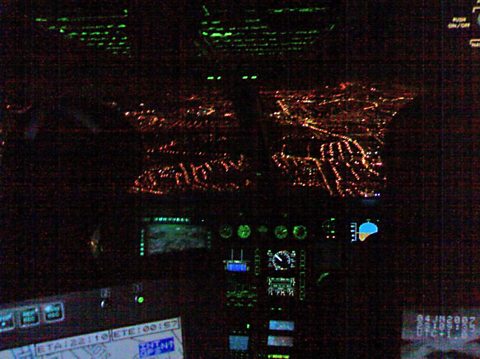 The view of the city from the cockpit at night